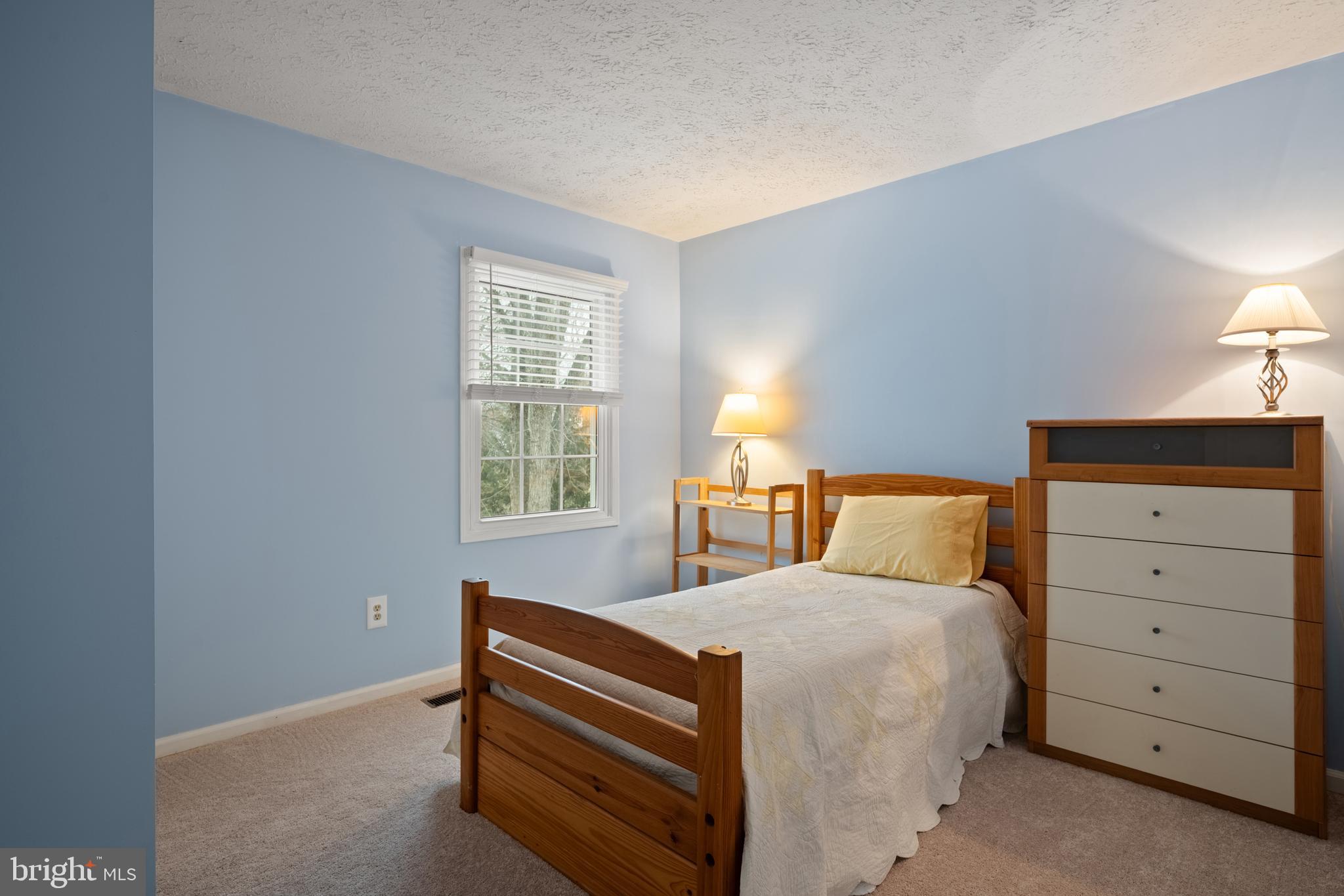 1374 Rock Chapel Road Herndon, VA 20170 - Photo 25 of 38 a bed room with a bed and a dresser