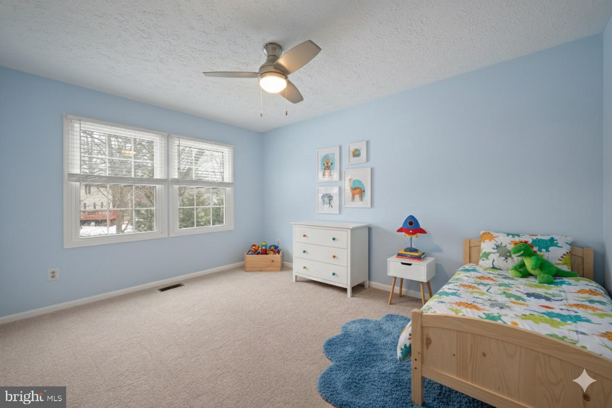 1374 Rock Chapel Road Herndon, VA 20170 - Photo 26 of 38 a bedroom with a bed and a chandelier
