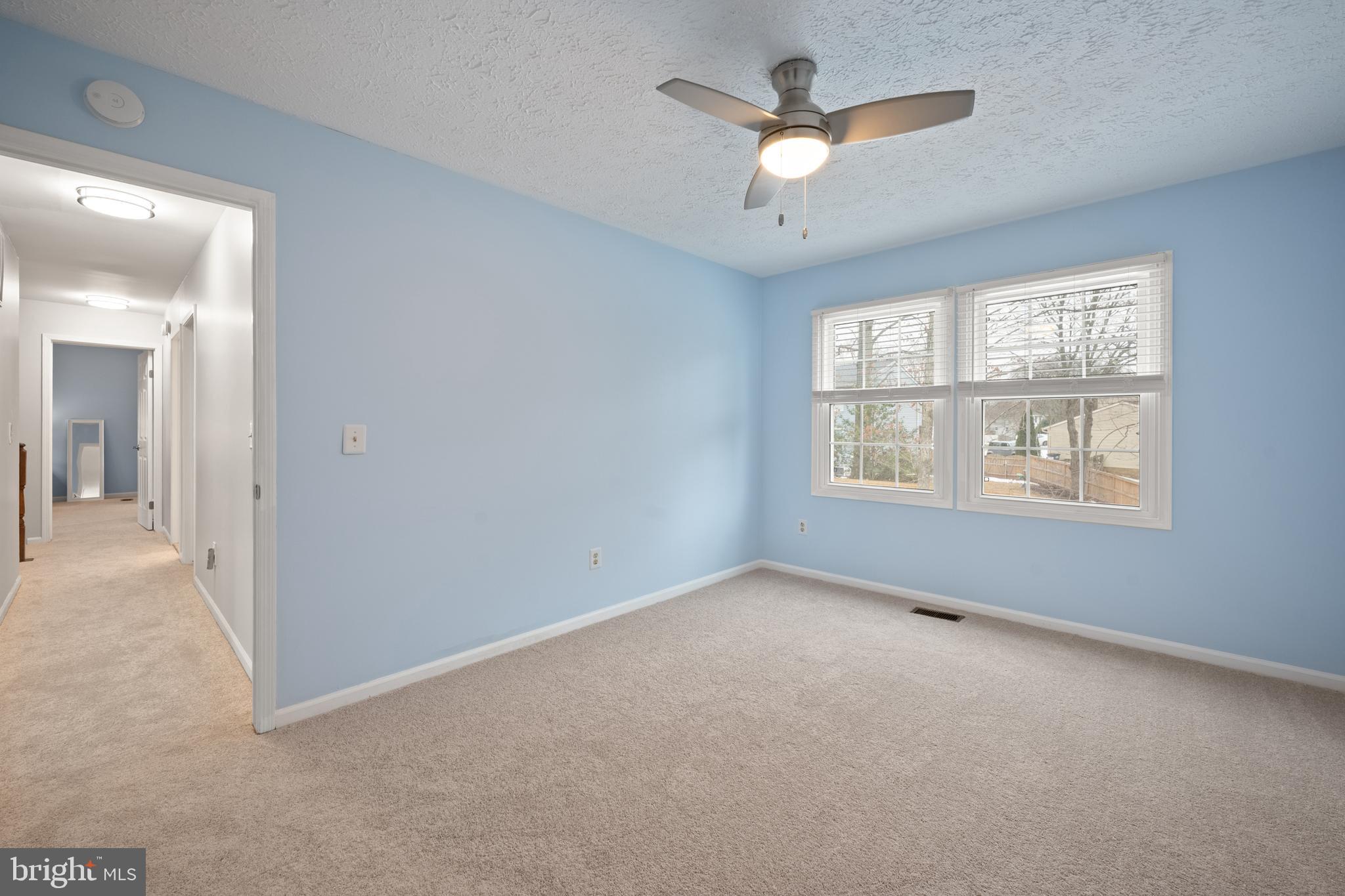 1374 Rock Chapel Road Herndon, VA 20170 - Photo 27 of 38 an empty room with a window and a ceiling fan