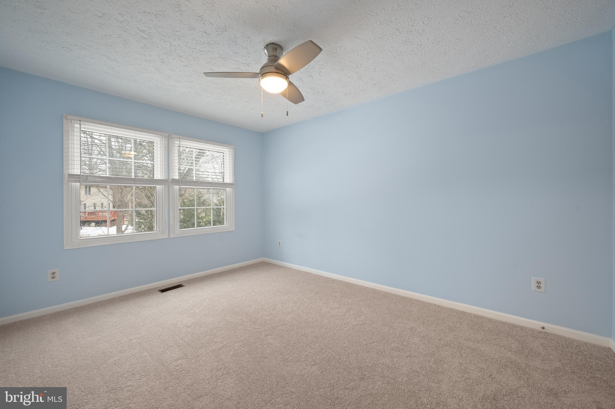 1374 Rock Chapel Road Herndon, VA 20170 - Photo 28 of 38 an empty room with windows and chandelier fan