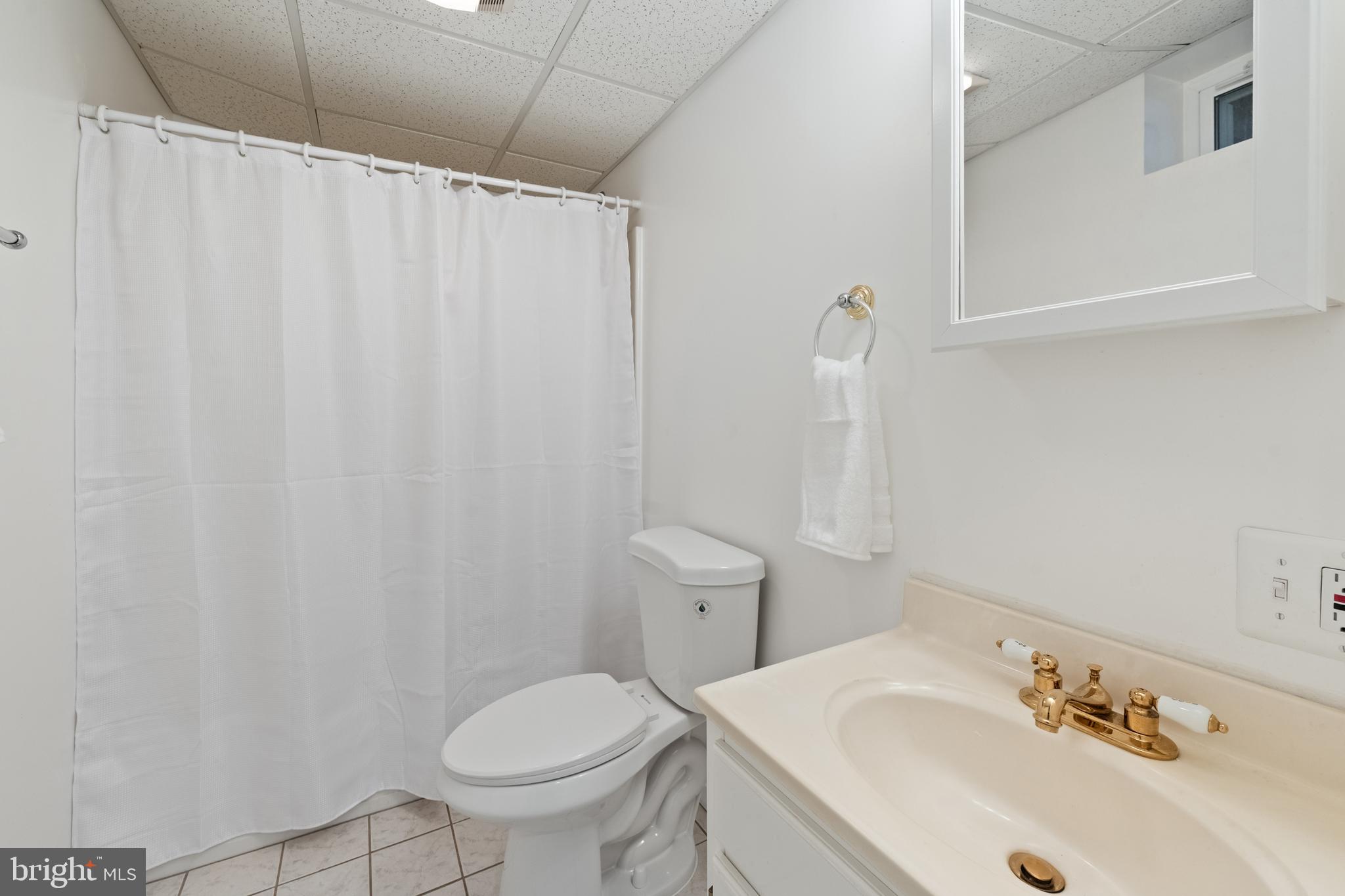1374 Rock Chapel Road Herndon, VA 20170 - Photo 31 of 38 a bathroom with a sink a toilet and shower curtain
