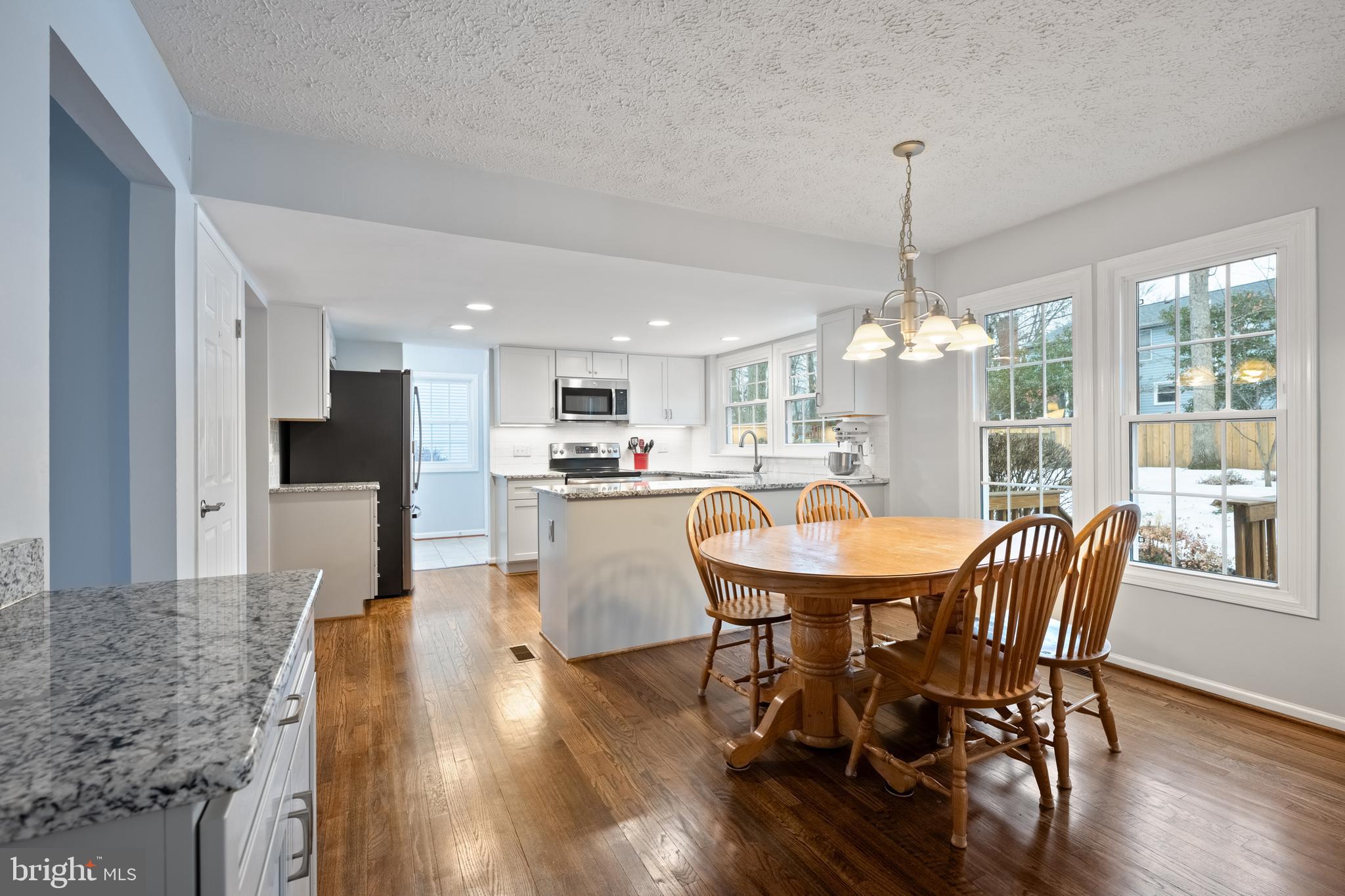 1374 Rock Chapel Road Herndon, VA 20170 - Photo 7 of 38 a dining room with furniture a chandelier and wooden floor