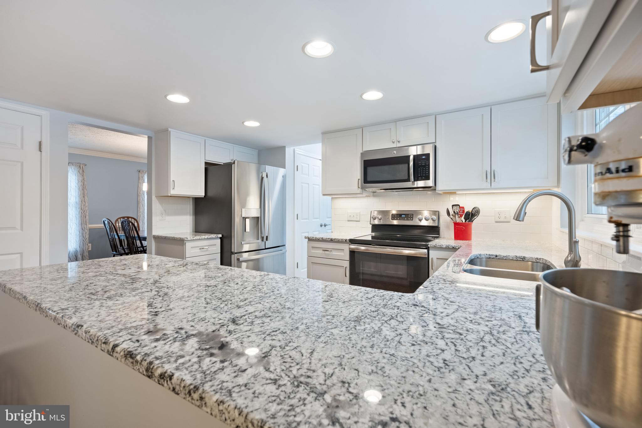 1374 Rock Chapel Road Herndon, VA 20170 - Photo 8 of 38 a kitchen with granite countertop a stove a sink and a refrigerator