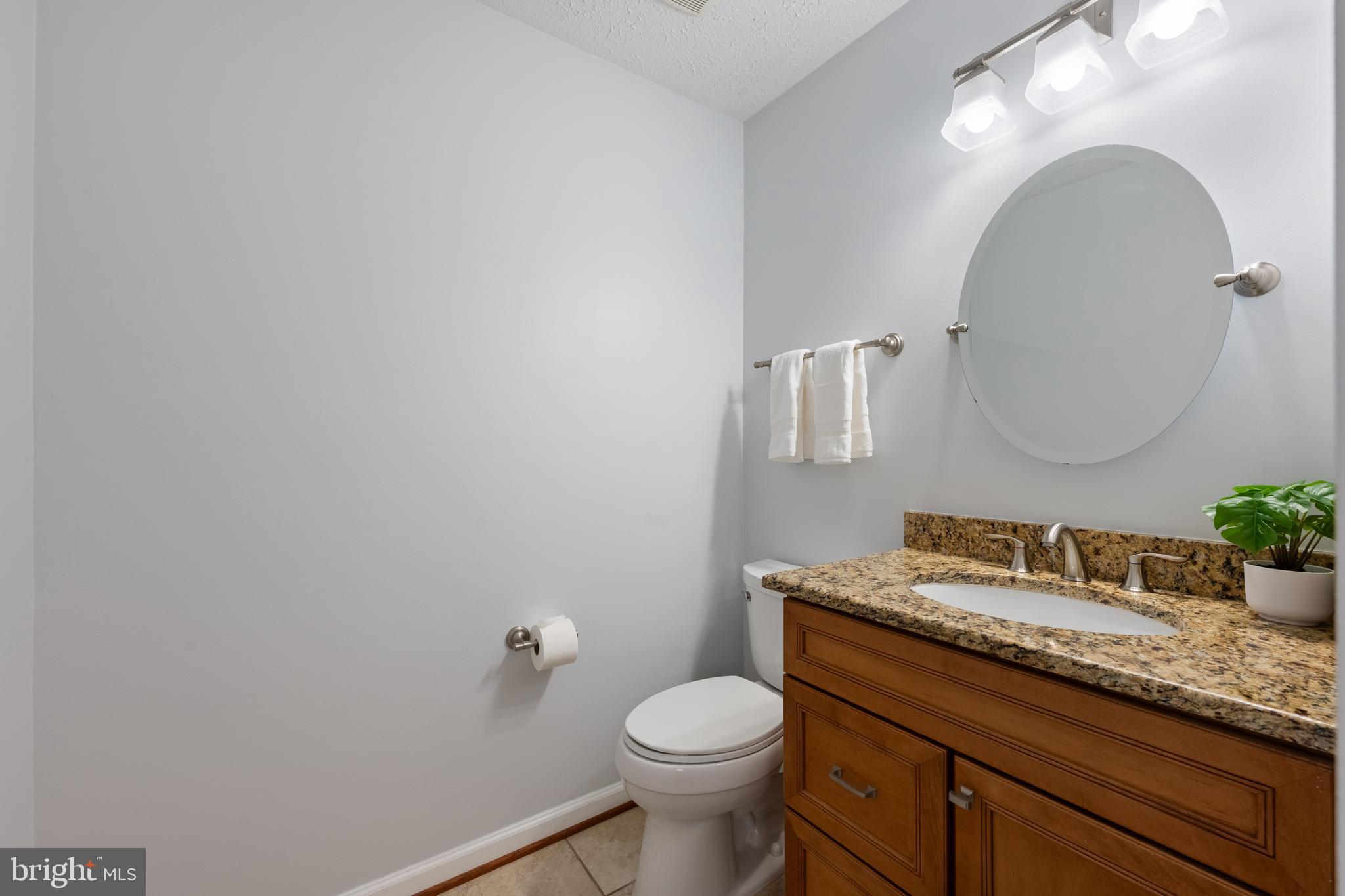 1374 Rock Chapel Road Herndon, VA 20170 - Photo 10 of 38 a bathroom with a granite countertop toilet sink and mirror
