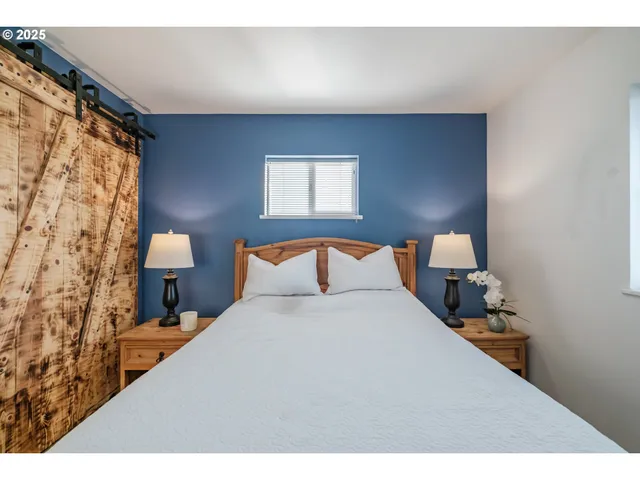 a bedroom with a bed and a lamp