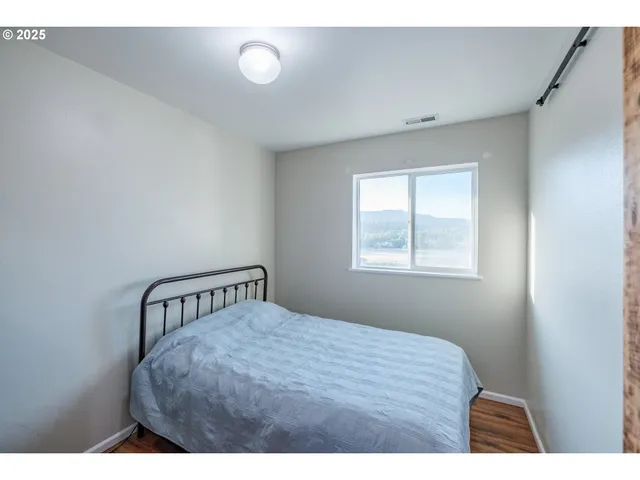 a bedroom with a bed and window