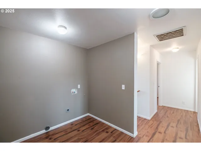 a view of an empty room and wooden floor