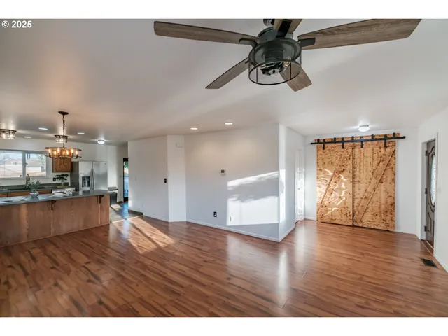 a view of empty room with wooden floor