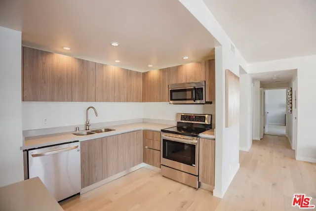 a backyard of a house with barbeque oven table and chairs