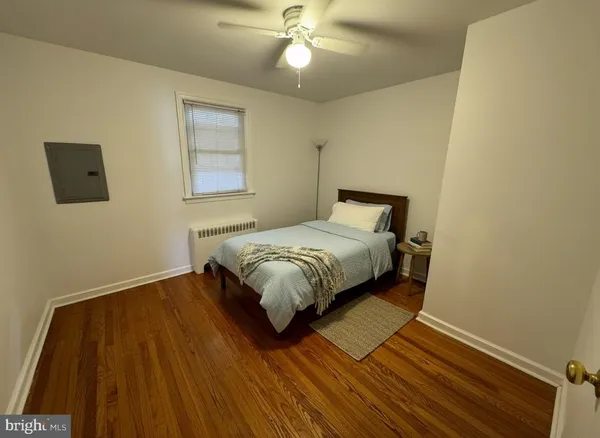 a bed sitting in a bedroom next to a window