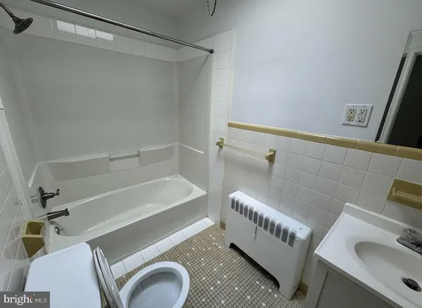 a bathroom with a tub a sink and a toilet