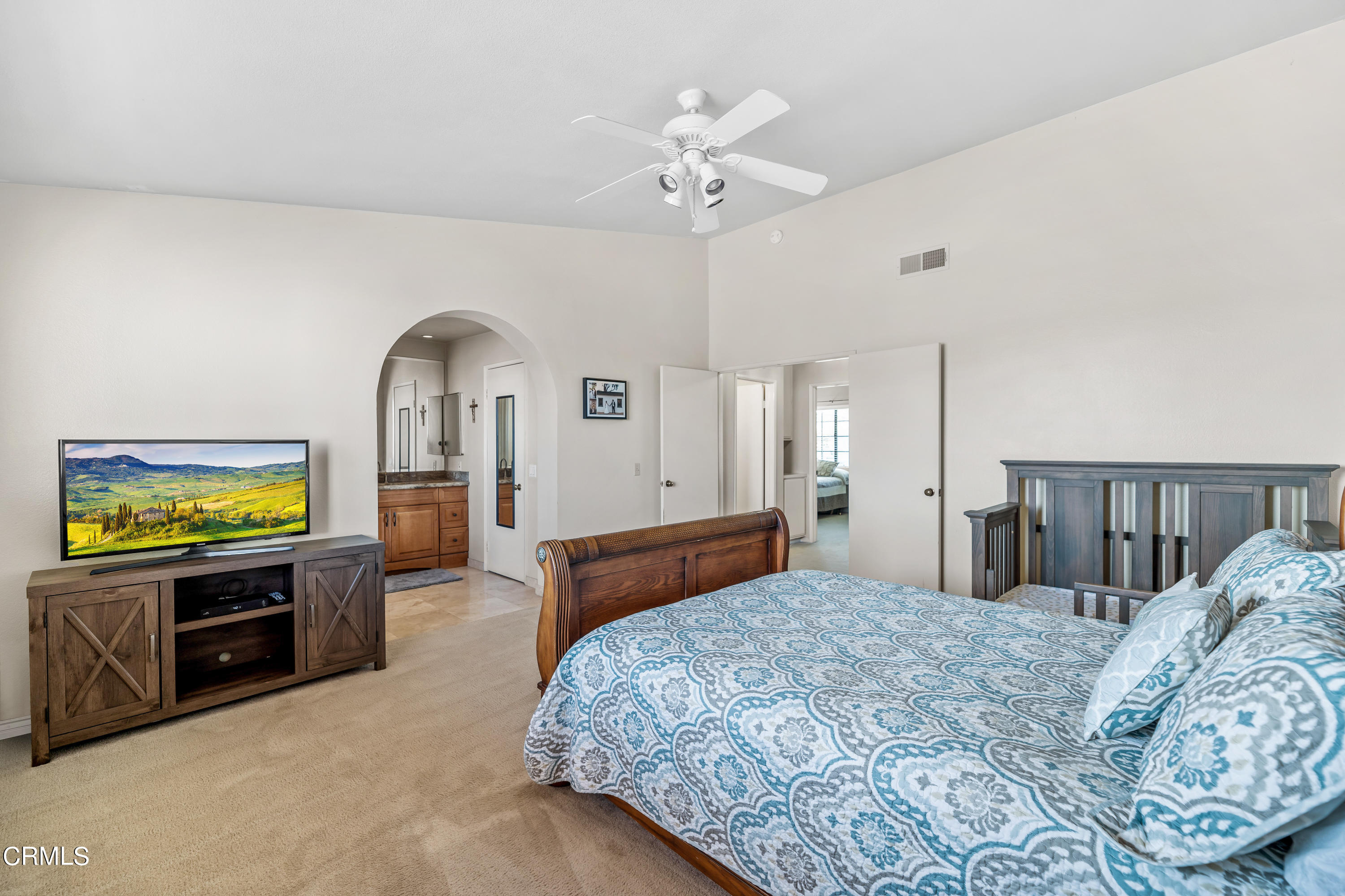 3554 Olds Road Oxnard, CA 93033 - Photo 16 of 27 a bedroom with a bed a dresser and potted plants with wooden floor