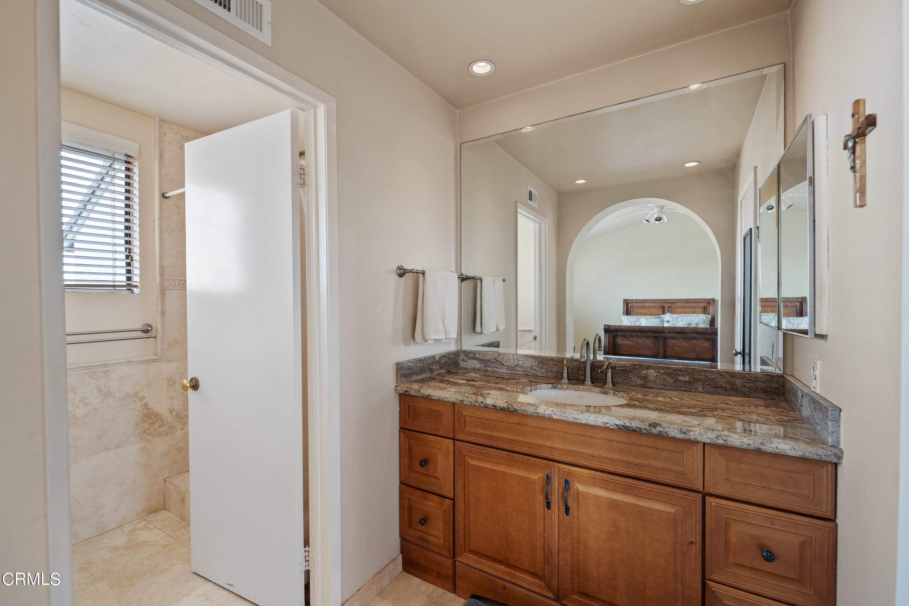 3554 Olds Road Oxnard, CA 93033 - Photo 17 of 27 a bathroom with a granite countertop sink a mirror and shower