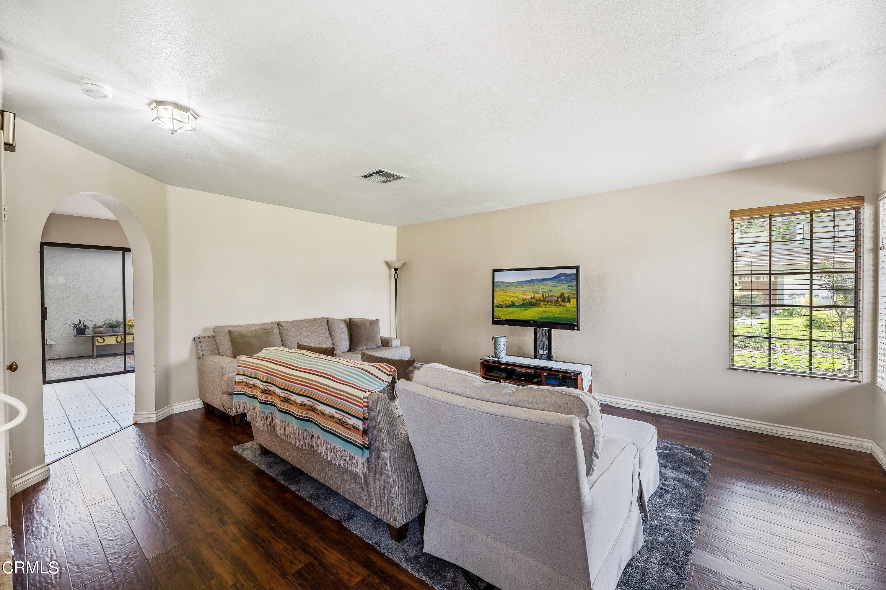 3554 Olds Road Oxnard, CA 93033 - Photo 3 of 27 a bedroom with a bed and wooden floor