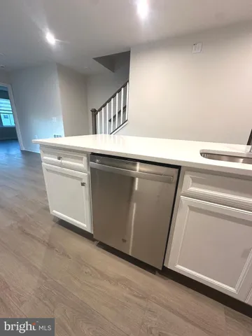 a kitchen with a sink and cabinets