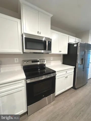 a kitchen with a stove microwave and refrigerator