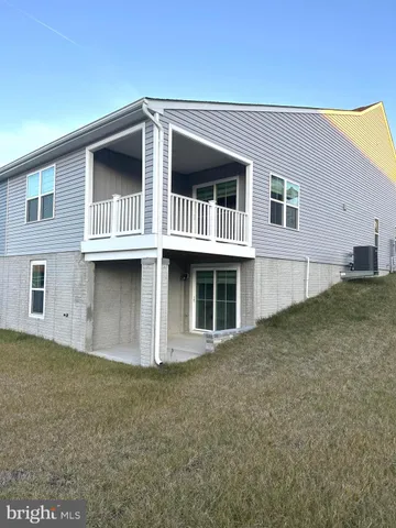 a front view of a house with plants
