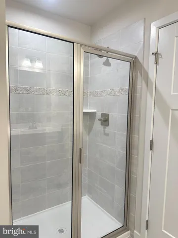 a bathroom with a glass shower door