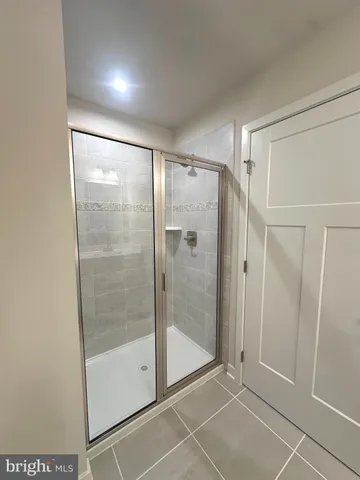 a bathroom with a glass shower door