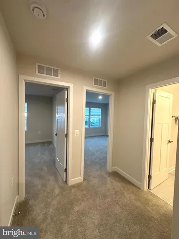 a view of a hallway with wooden shelves