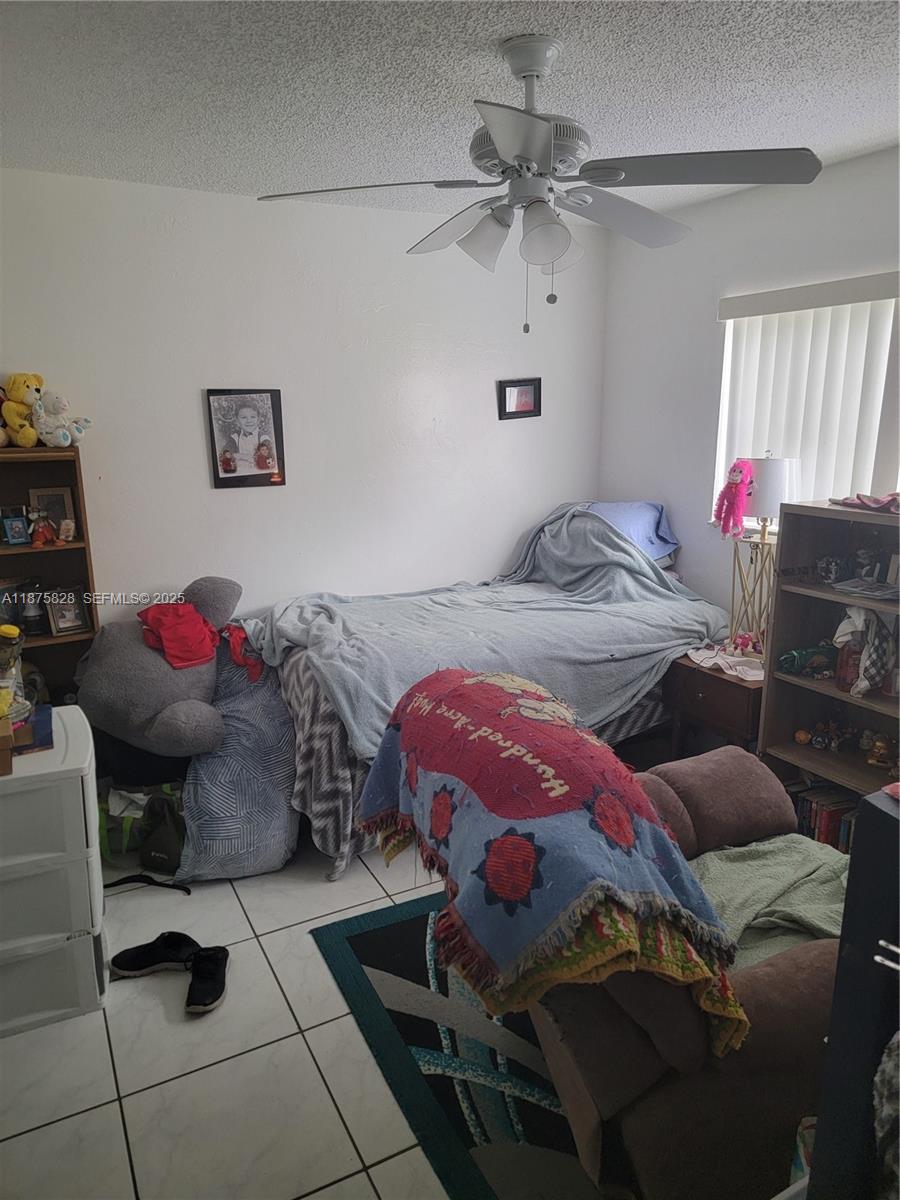 1670 Harding Street Hollywood, FL 33020 - Photo 7 of 19 a bedroom with furniture and a chandelier