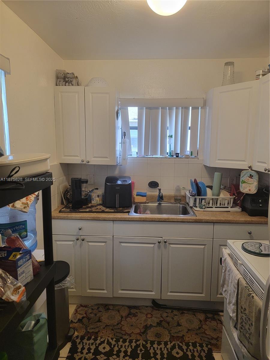 1670 Harding Street Hollywood, FL 33020 - Photo 9 of 19 a kitchen with stainless steel appliances a stove a sink and a refrigerator