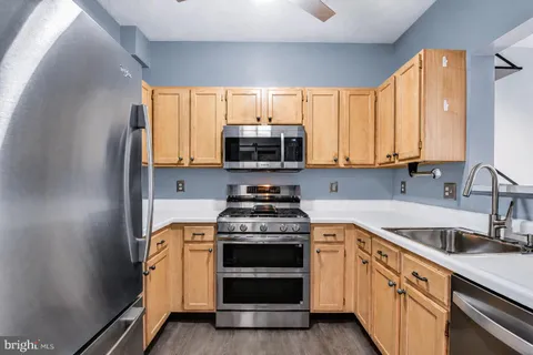a kitchen with a stove a sink and a microwave