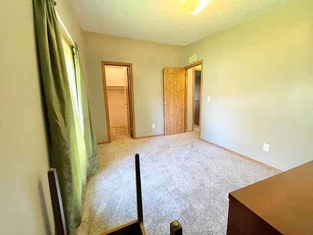 a view of an empty room and glass door