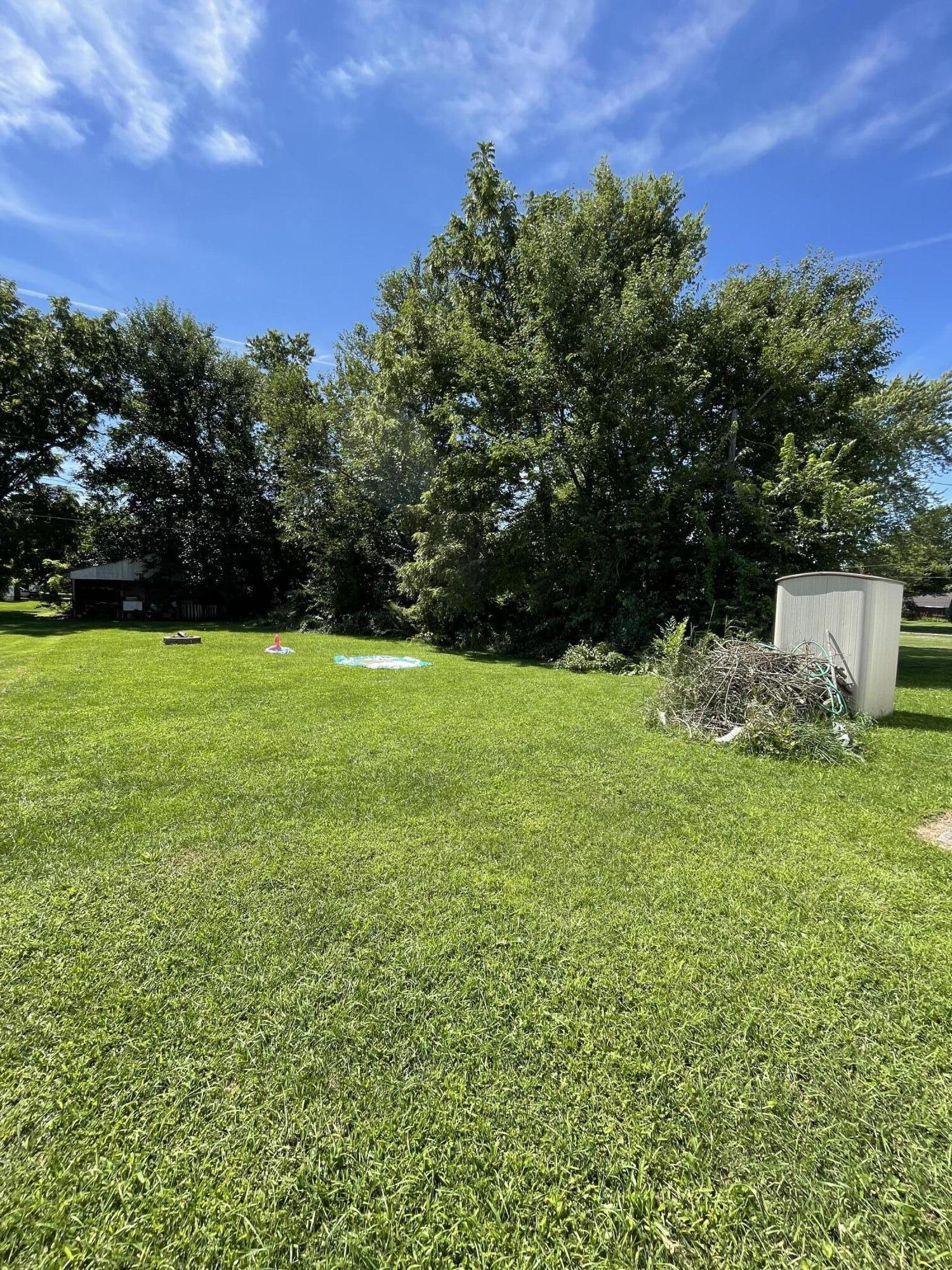 605 East Washington Street Morocco, IN 47963 - Photo 13 of 13 a view of a garden with a building in the background