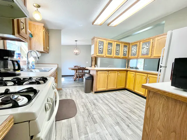 a kitchen that has a sink and a stove in it