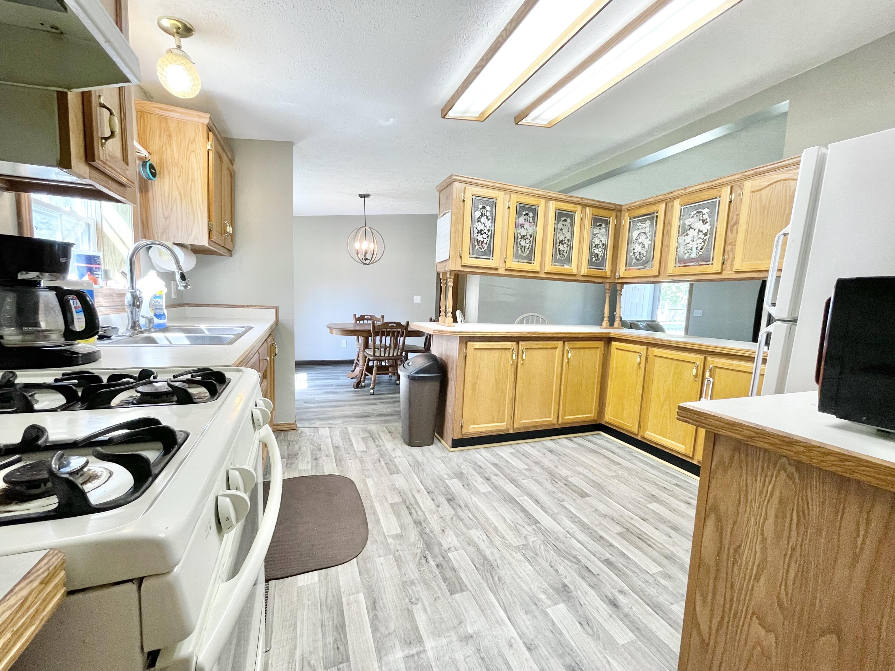 605 East Washington Street Morocco, IN 47963 - Photo 5 of 13 a kitchen that has a sink and a stove in it