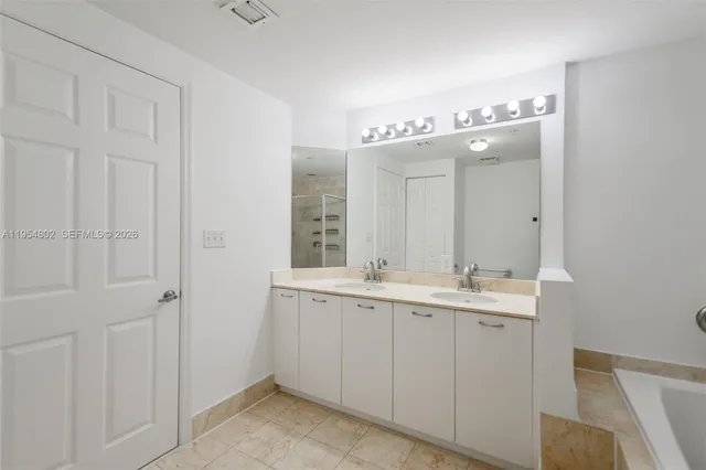 a bathroom with a bathtub and a shower