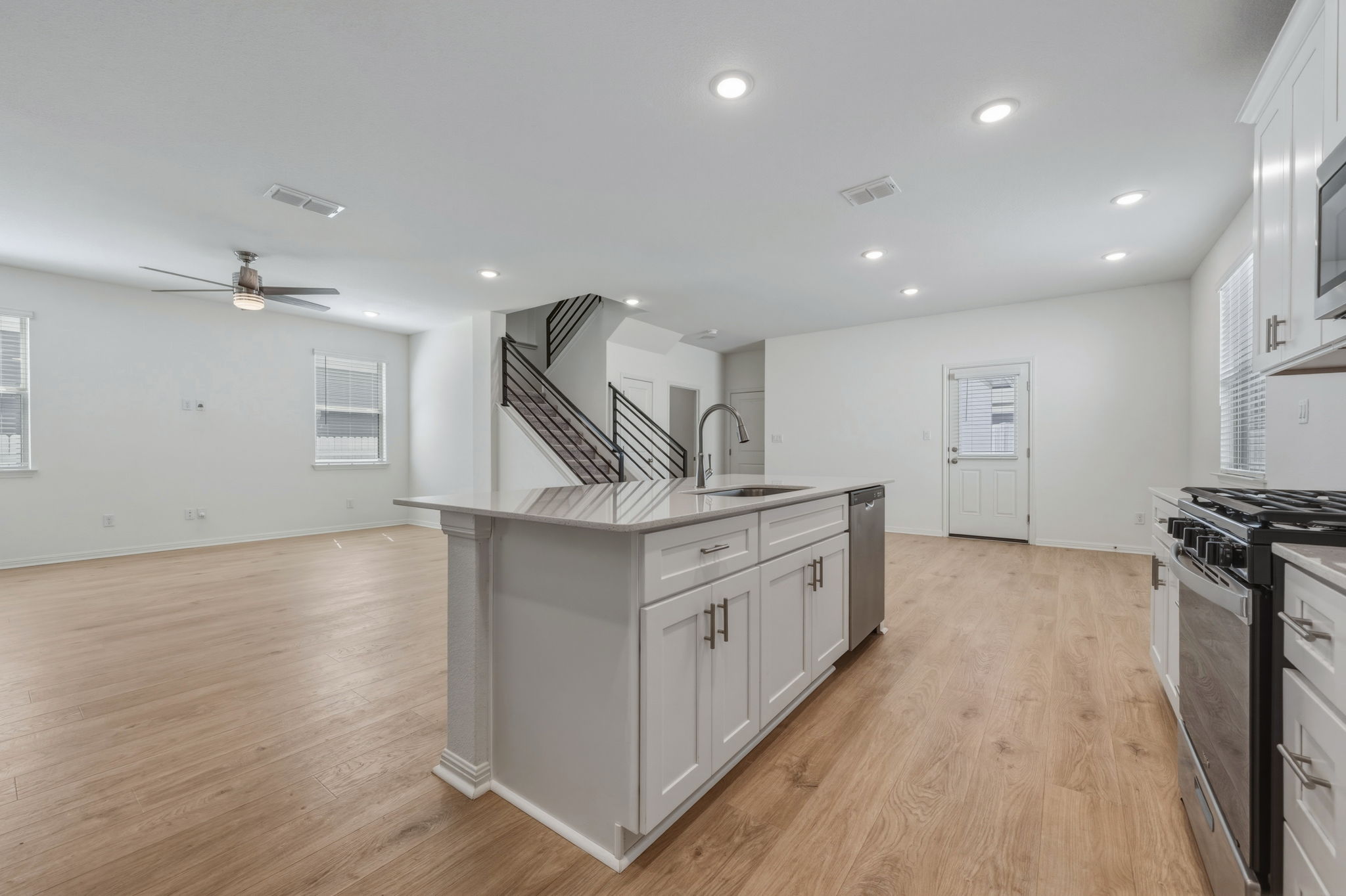 223 Rieber Road Kyle, TX 78640 - Photo 38 of 39 a kitchen with granite countertop a sink and a stove top oven