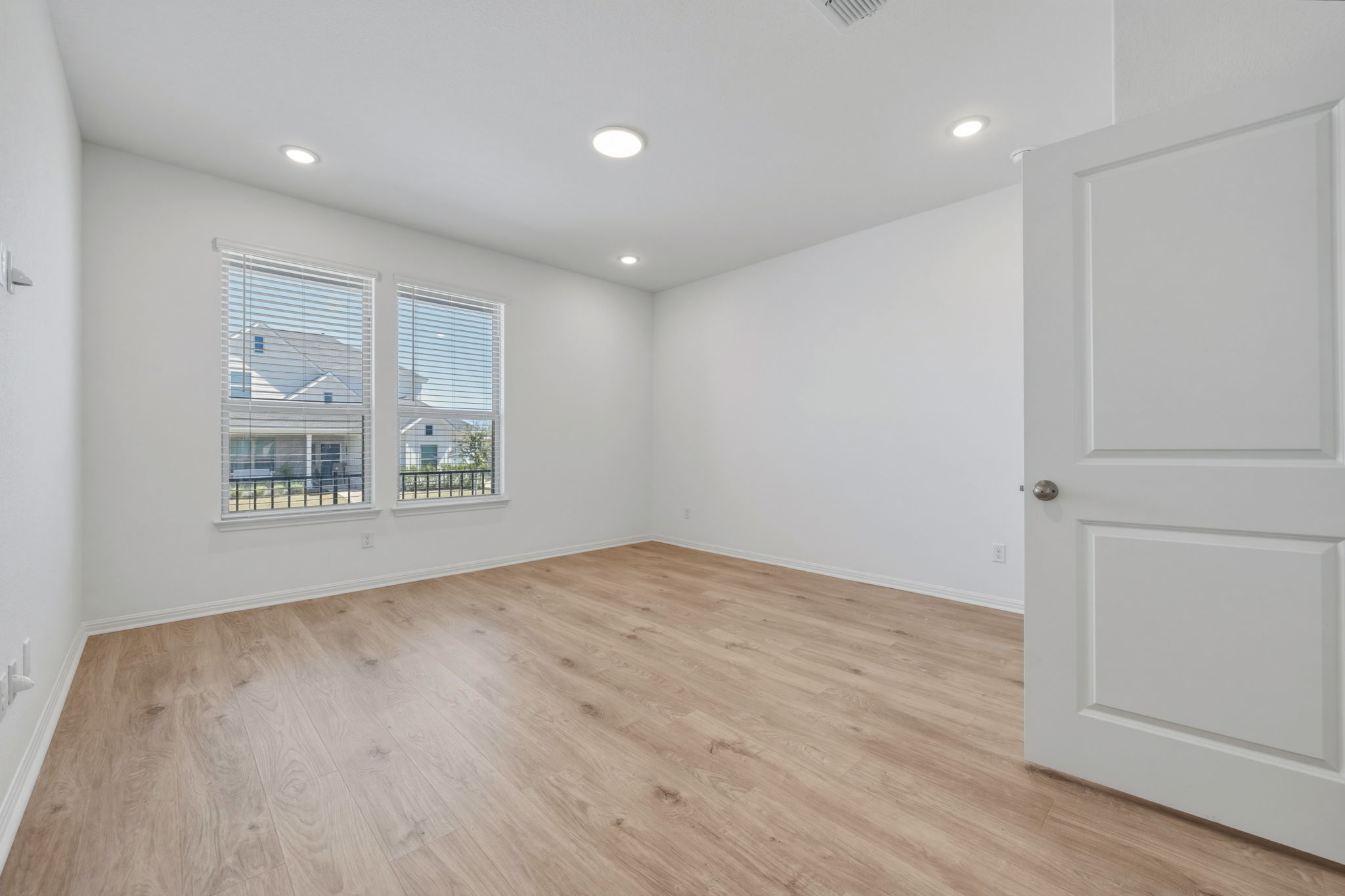 223 Rieber Road Kyle, TX 78640 - Photo 18 of 39 a view of an empty room with wooden floor and a window