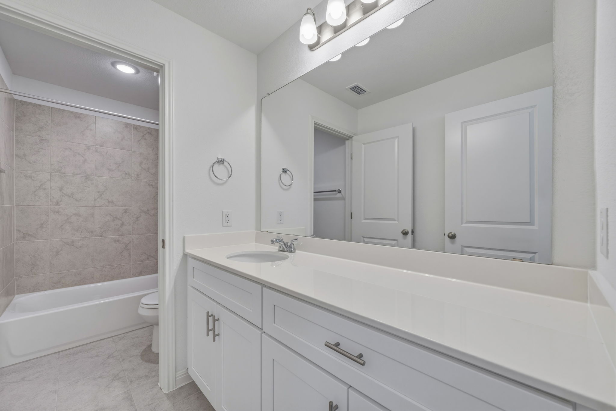 223 Rieber Road Kyle, TX 78640 - Photo 28 of 39 a bathroom with a sink a vanity and a bathtub
