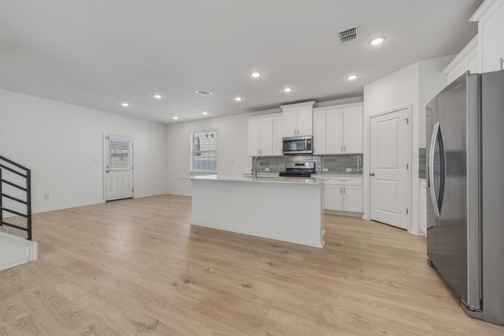 223 Rieber Road Kyle, TX 78640 - Photo 8 of 39 a kitchen with stainless steel appliances granite countertop a refrigerator sink and white cabinets
