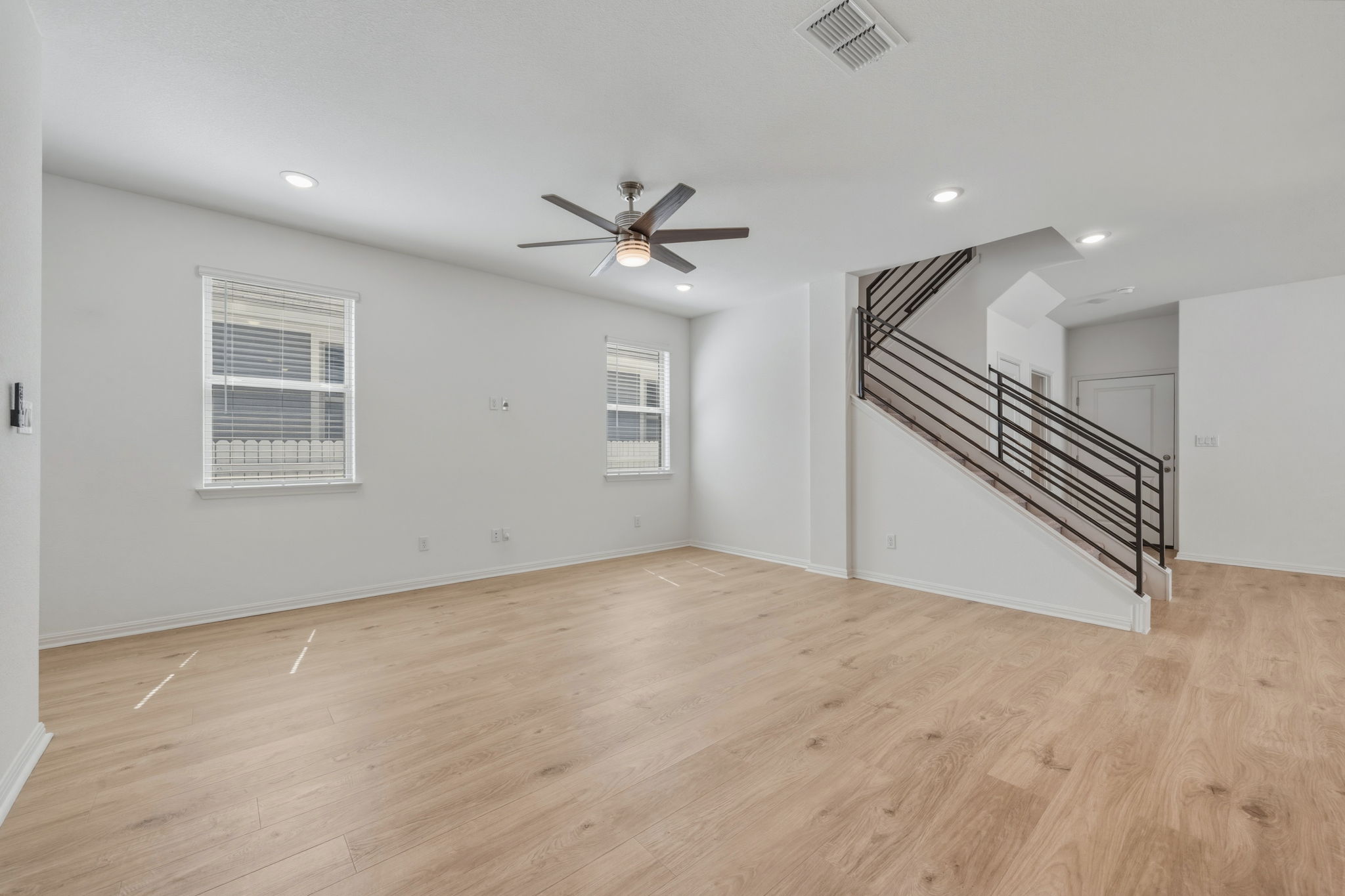 223 Rieber Road Kyle, TX 78640 - Photo 10 of 39 an empty room with windows and ceiling fan