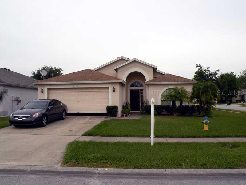 22510 Roderick Drive Land O' Lakes, FL 34639 - Photo 1 of 1 a car parked in front of a house