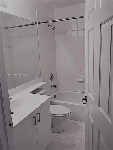 a bathroom with a granite countertop sink