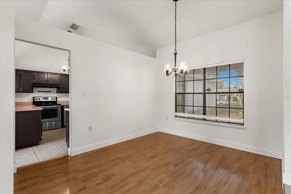 a view of a kitchen with a sink wooden floor and a kitchen counter top space