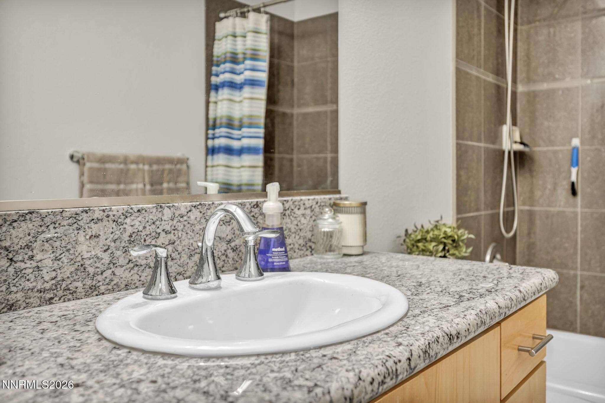 326 State Street Reno, NV 89501 - Photo 12 of 49 a bathroom with a granite countertop sink and a mirror