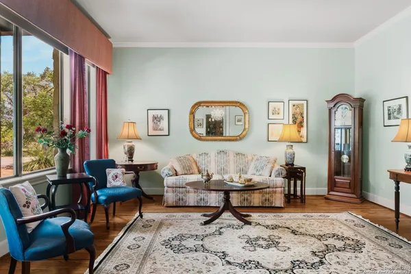 a living room with furniture and wooden floor