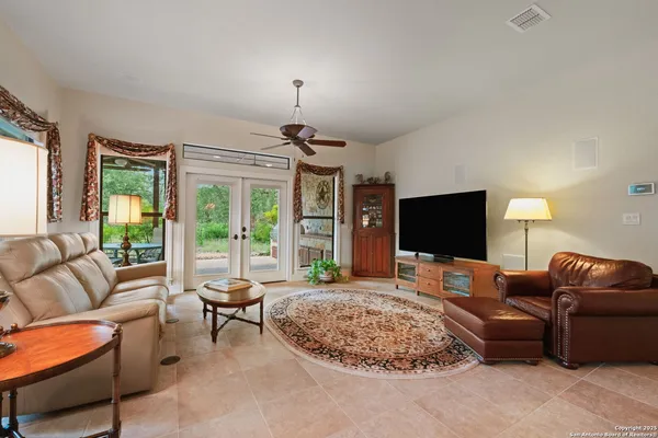 a living room with furniture and a book shelf