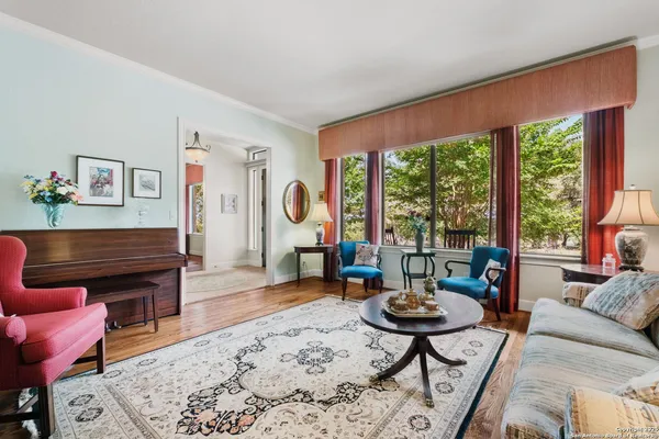 a living room with furniture a rug and a large window
