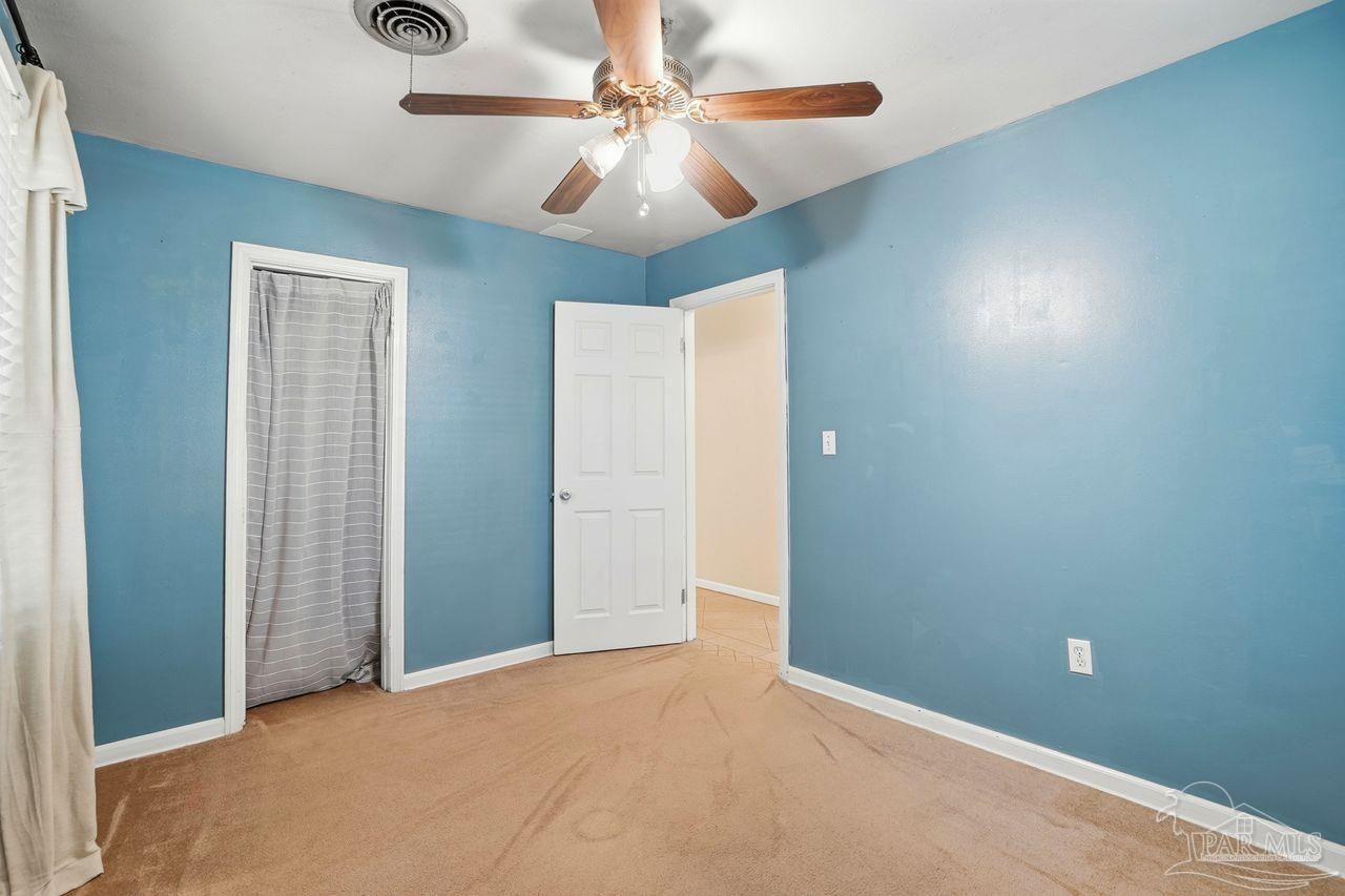 6444 Walnut Street Milton, FL 32570 - Photo 19 of 33 an empty room with fan and fan