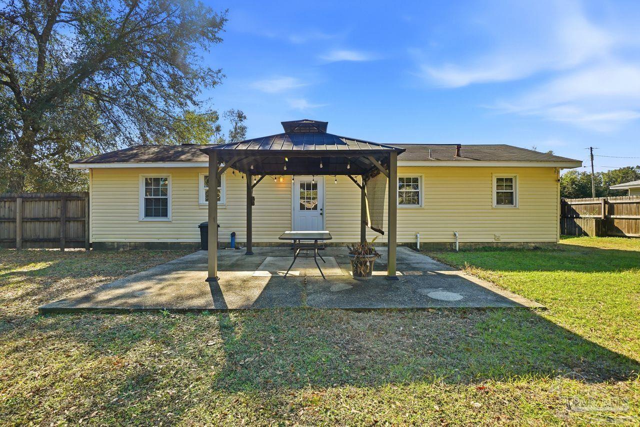 6444 Walnut Street Milton, FL 32570 - Photo 23 of 33 a backyard of a house with barbeque oven