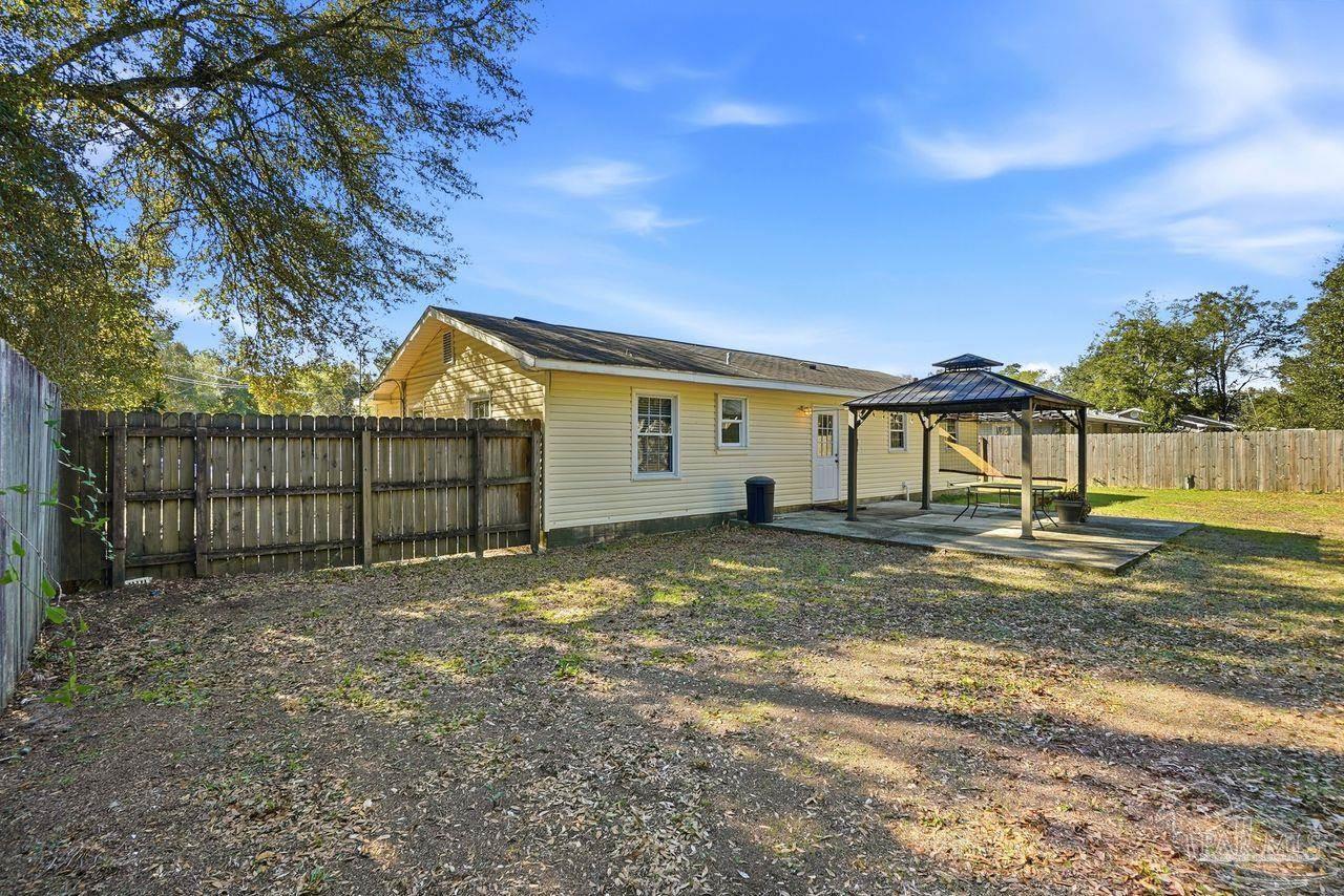 6444 Walnut Street Milton, FL 32570 - Photo 24 of 33 a view of a yard with wooden fence