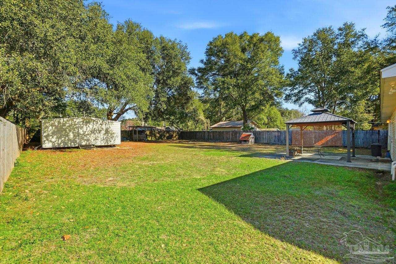 6444 Walnut Street Milton, FL 32570 - Photo 31 of 33 a view of a house with a yard