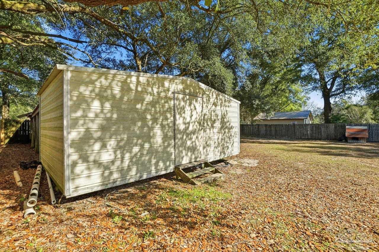 6444 Walnut Street Milton, FL 32570 - Photo 32 of 33 a backyard of a house with a tree