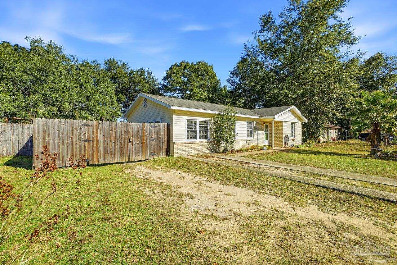 6444 Walnut Street Milton, FL 32570 - Photo 4 of 33 a house with trees in the background